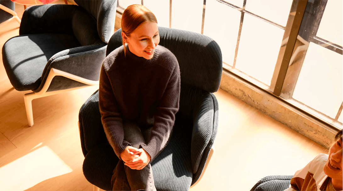 A colleague seated in a sunlit lounge.